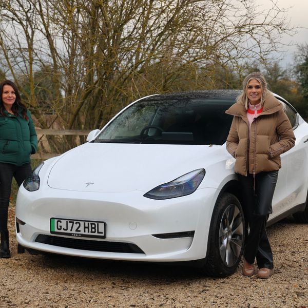 Ginny Buckley and Nicki Shields with a white Tesla Model Y